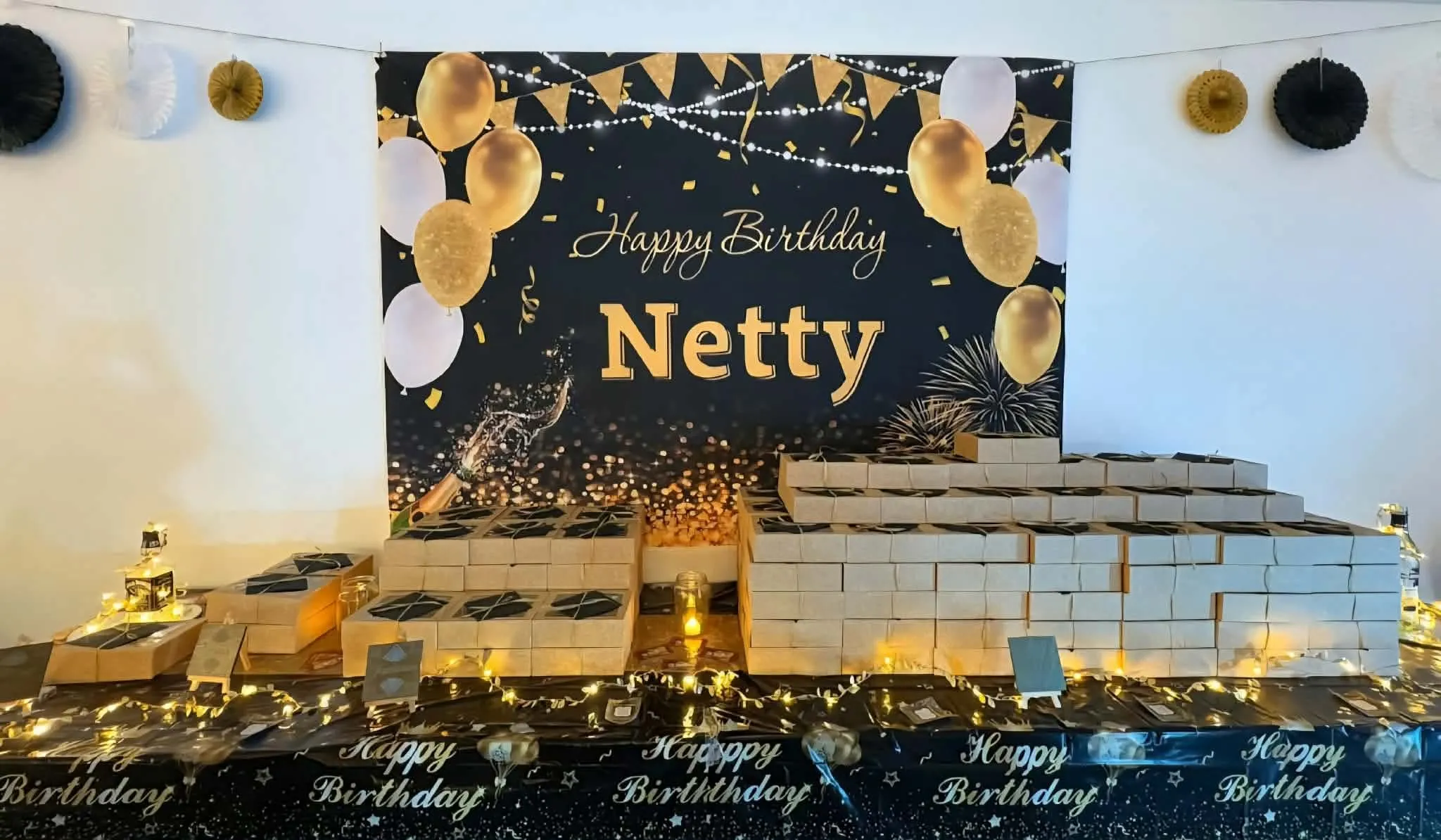 Birthday picnic boxes laid out for a party with prosecco