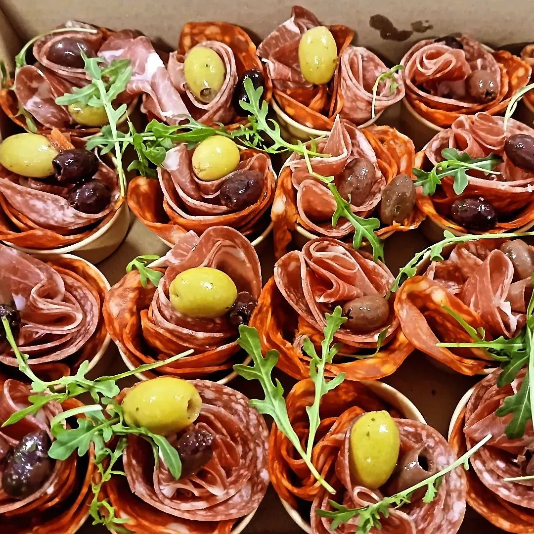 Charcuterie canapé cups laid on a board