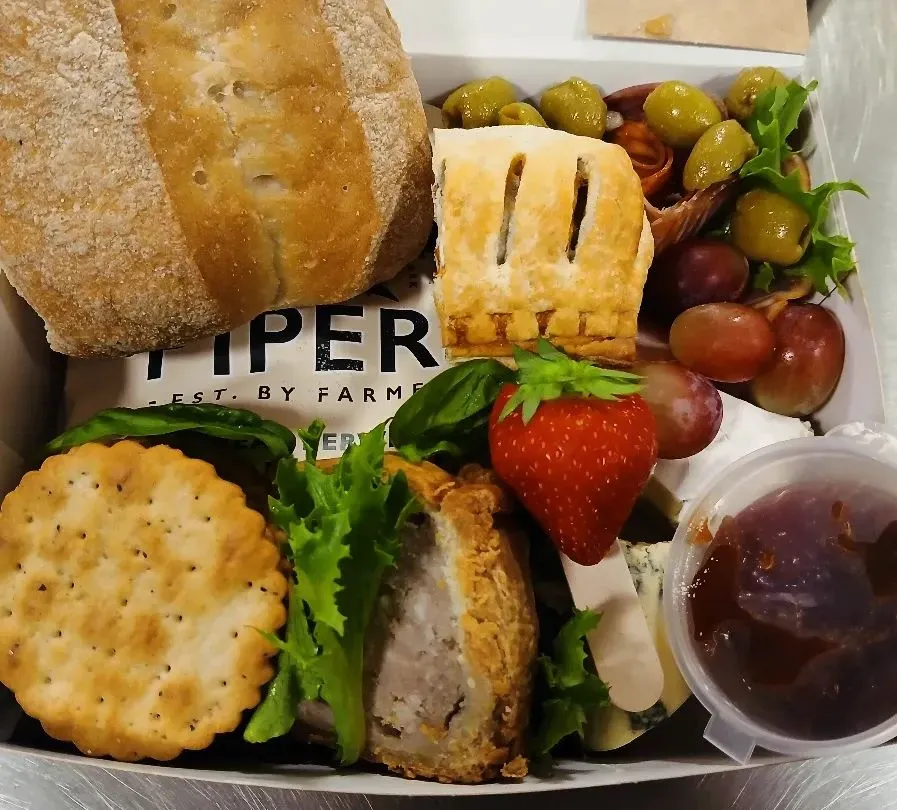 A graze hamper box with continental cheese, meats and bread