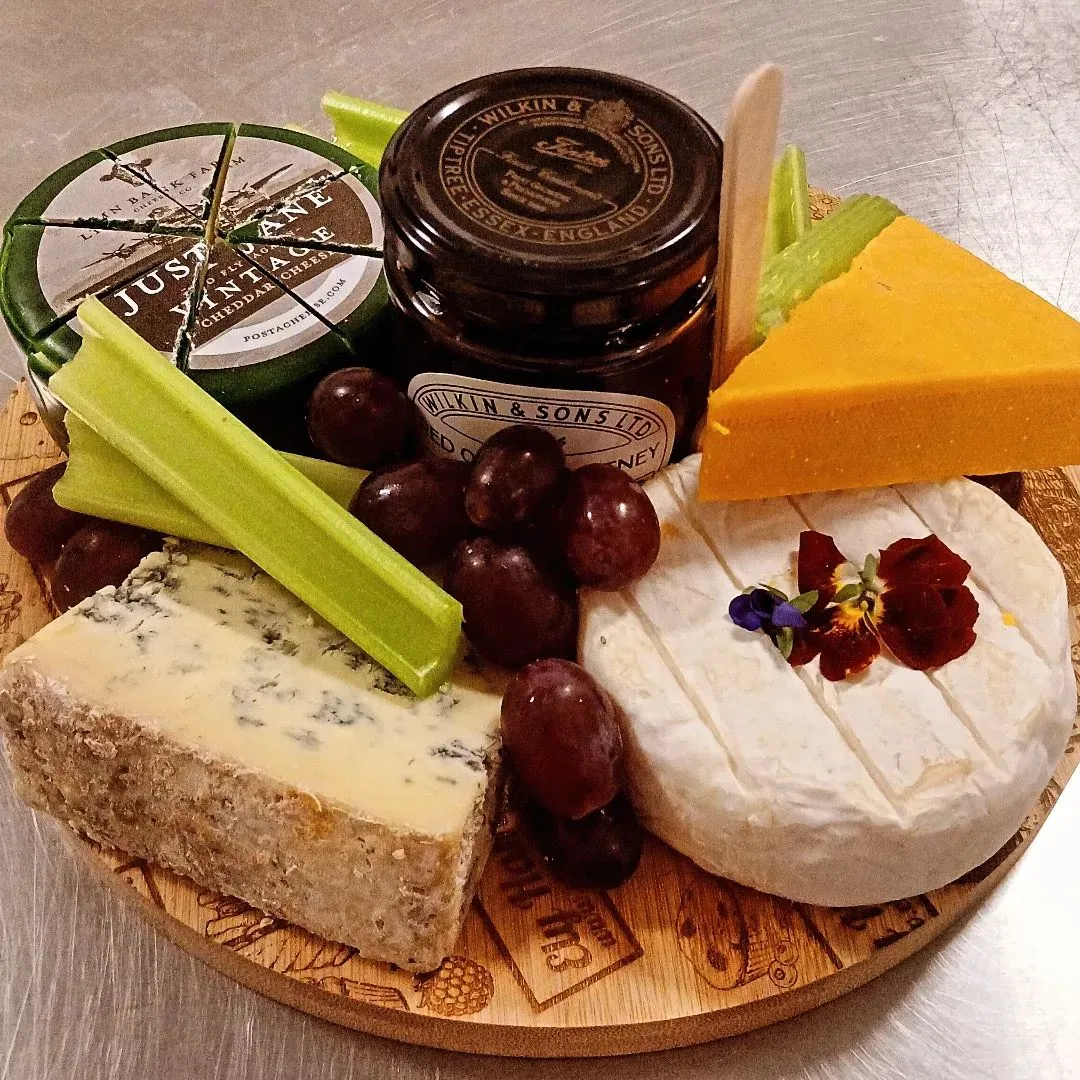 Cheese board with grapes and chutney