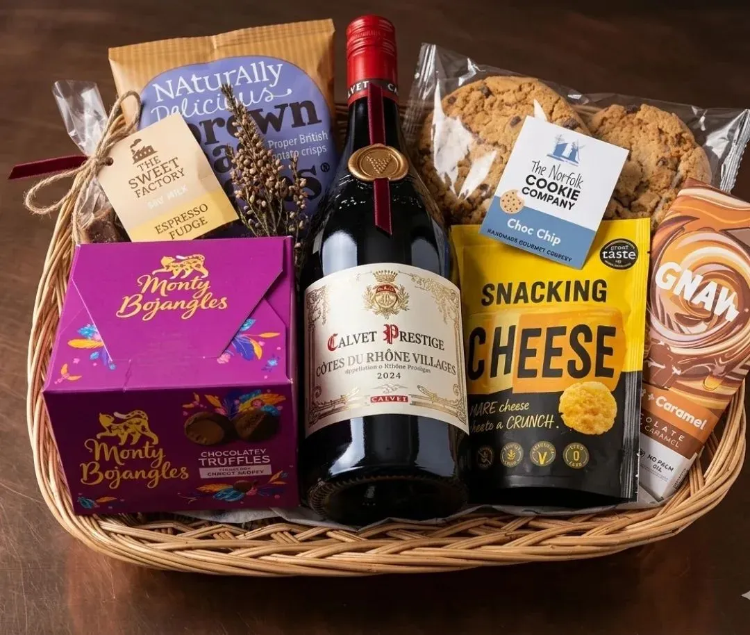 Wicker tray with red wine, snacks, fudge and chocolates