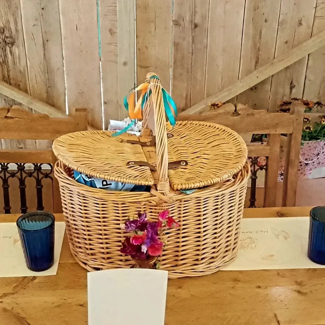 A long picnic table with sharing hampers and dressed glassware